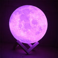 3D printed spherical moon lamp with textured surface on a wooden stand, showing white LED light.