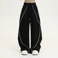 Black and white striped pleated wide-leg hip hop pants on a neutral background