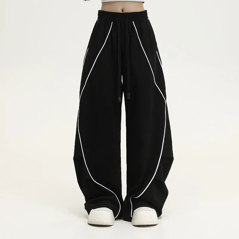 Black and white striped pleated wide-leg hip hop pants on a neutral background