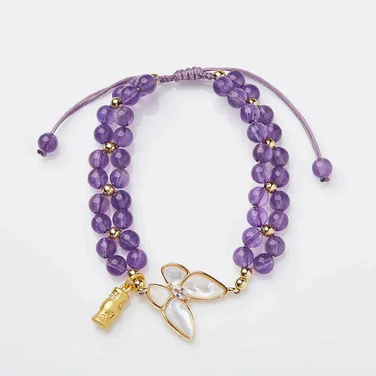 Handmade purple amethyst crystal bracelet with multi-treasure natural stone beads on white background