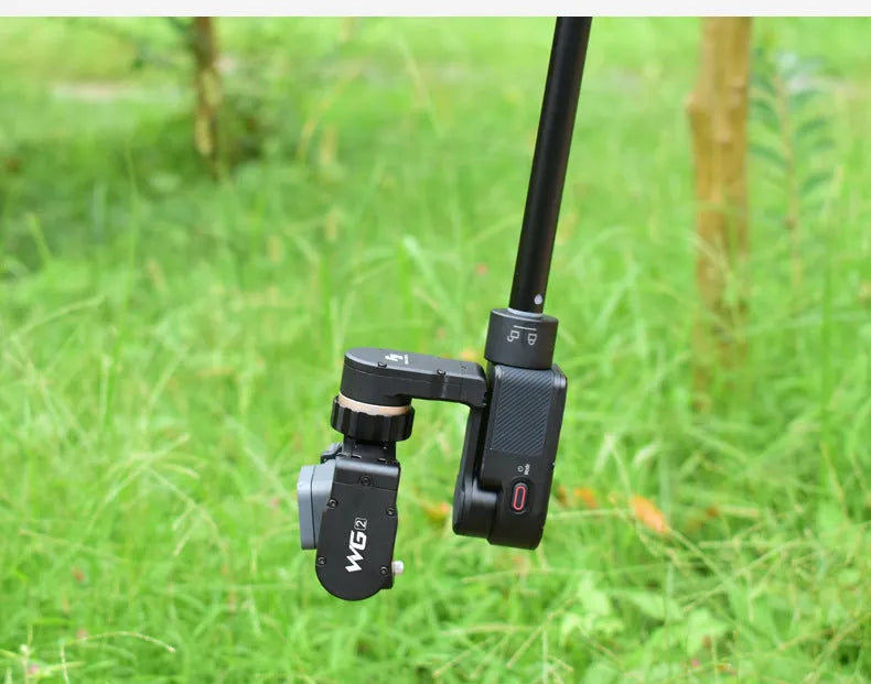 Black retractable aluminium selfie stick extended to 100cm with smartphone attached and Bluetooth remote.