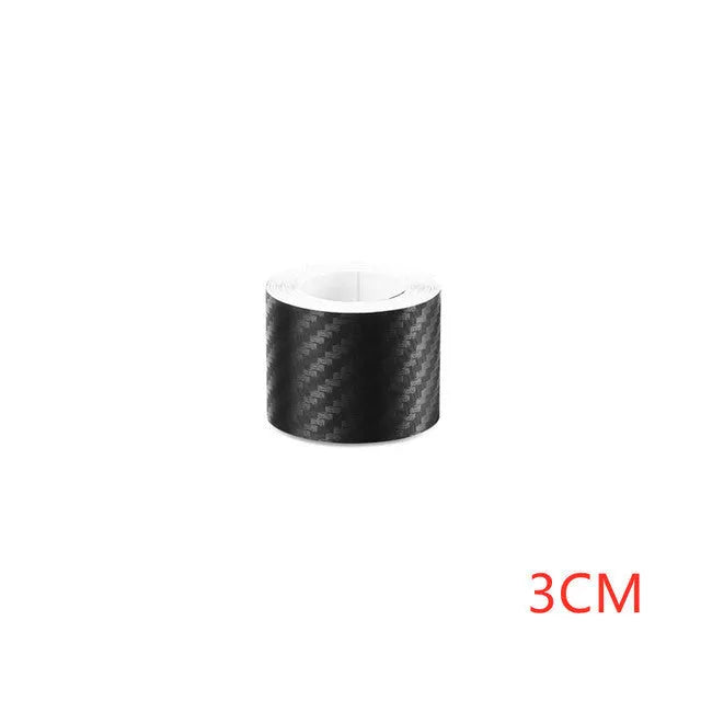 Matte black 3D carbon fibre adhesive protection roll for car door sills in various widths.