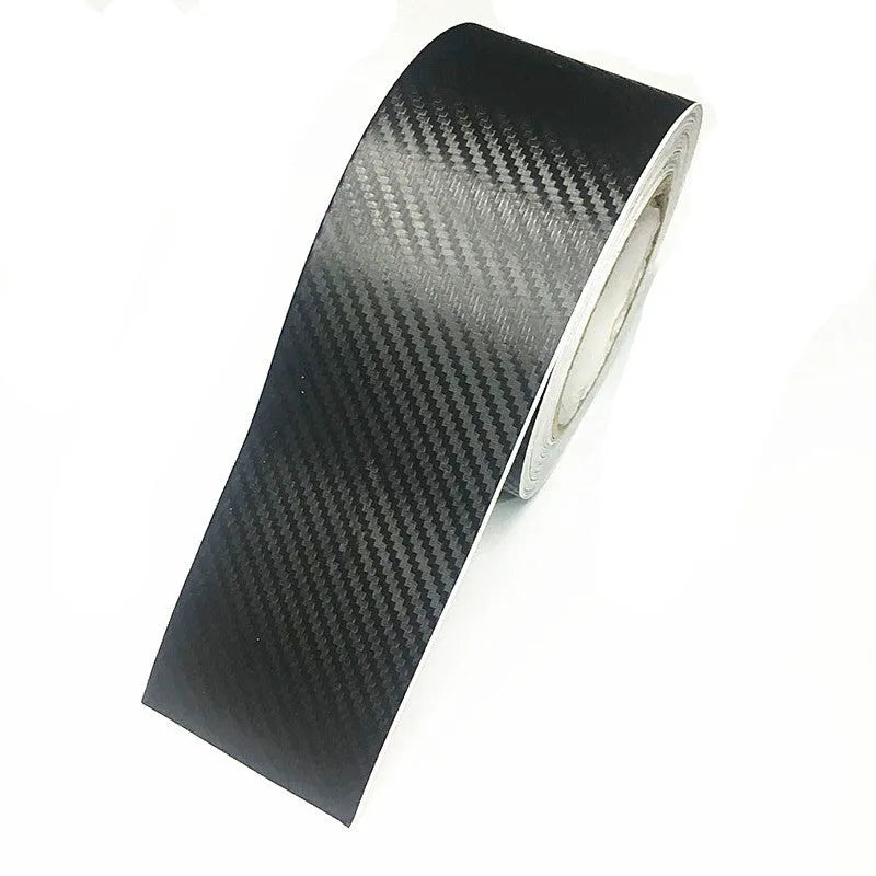 Matte black 3D carbon fibre adhesive protection roll for car door sills in various widths.
