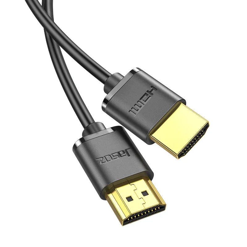 Thin flexible HDMI video cable with gold-plated connectors on a white background.