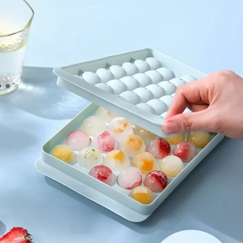 Blue silicone ice cube tray with lid showing 33 round ice moulds