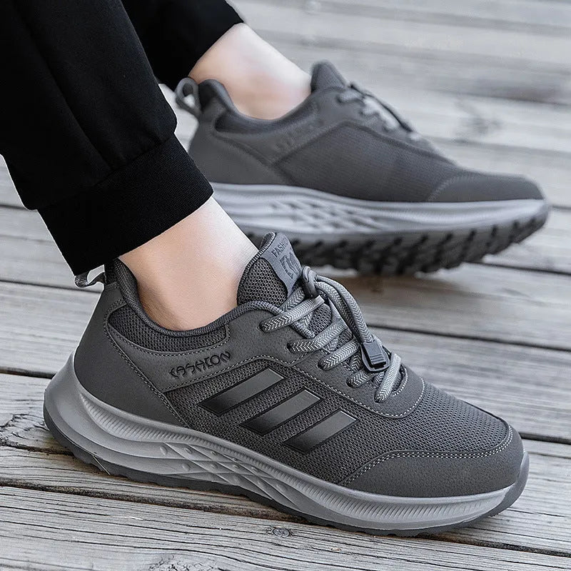 Casual unisex slip-on shoe with mesh upper and black elastic band fastening on a non-slip sole.