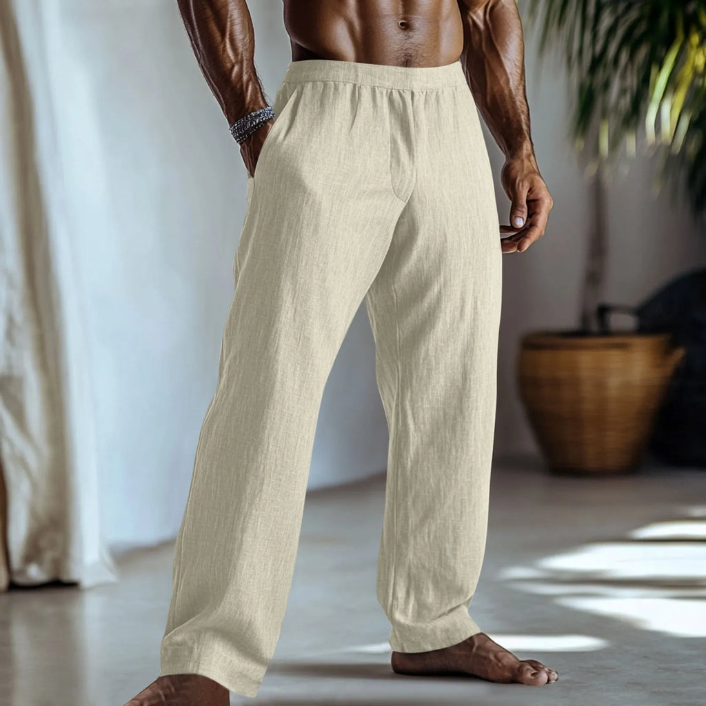 Straight leg cotton linen trousers in light green colour with visible front pockets on a plain background