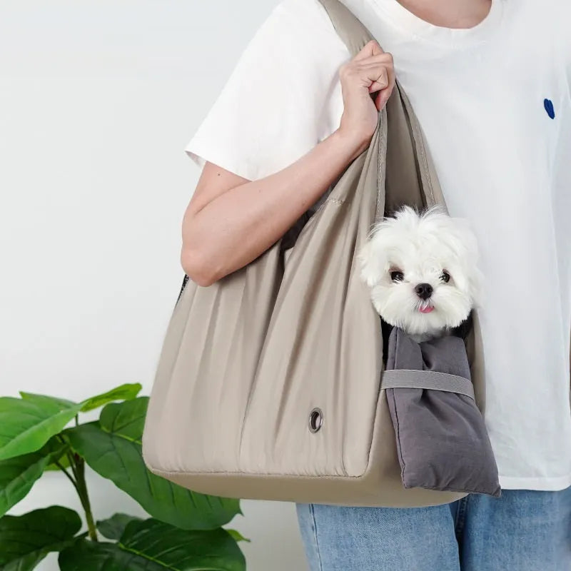 Apricot coloured cloth pet carrier handbag for small dogs or cats, showing carrying handles.