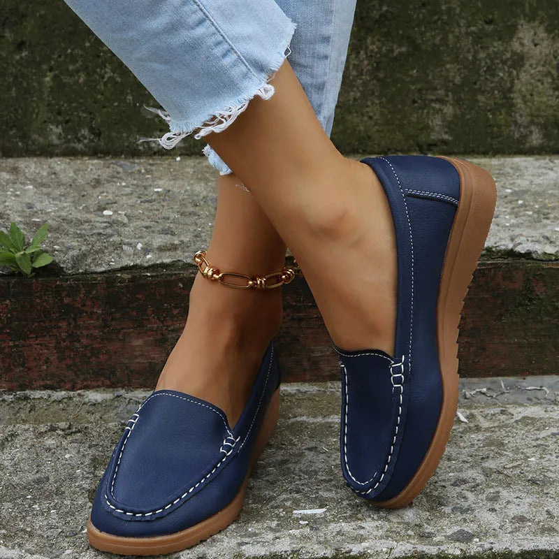 Women's flat loafer shoes in PU leather, showing round toe and car suture detail, on a rubber sole.