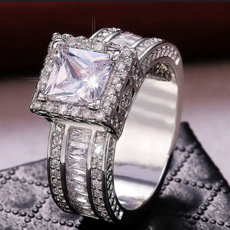 Geometric women's alloy ring with round details in gold or white electroplated finish.