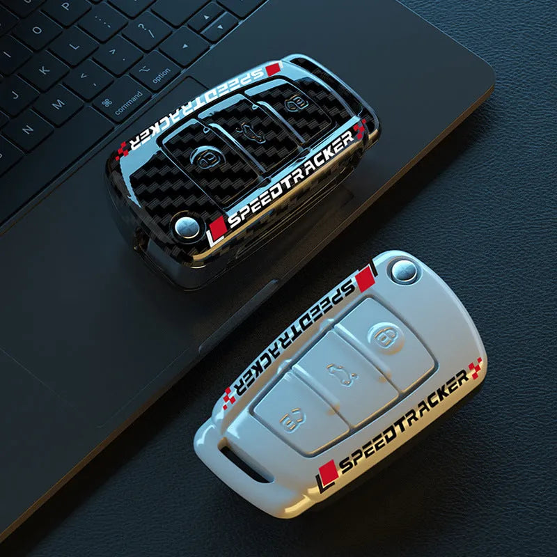 White and carbon coloured car key holders with a carbon fibre texture and mirror surface.