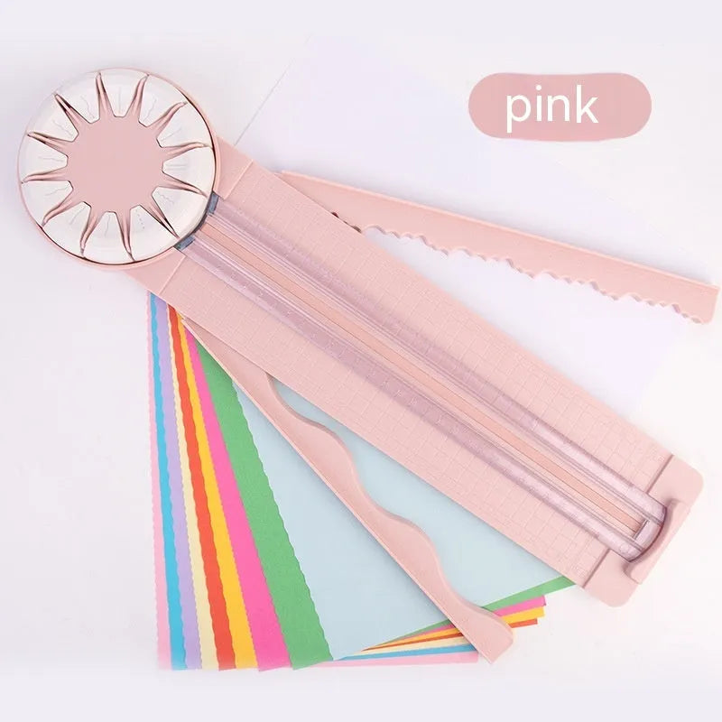Pink plastic 12-in-1 multifunctional paper cutter with dotted guide lines on a white surface.