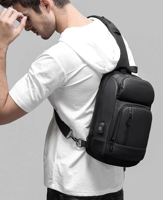 Black PVC outdoor leisure shoulder bag with internal organiser pockets and air cushion strap