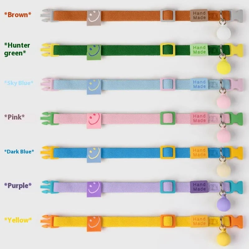 Small elastic polyester dog collar shown in various colours, adjustable from 22 to 32 cm for tiny dog breeds.