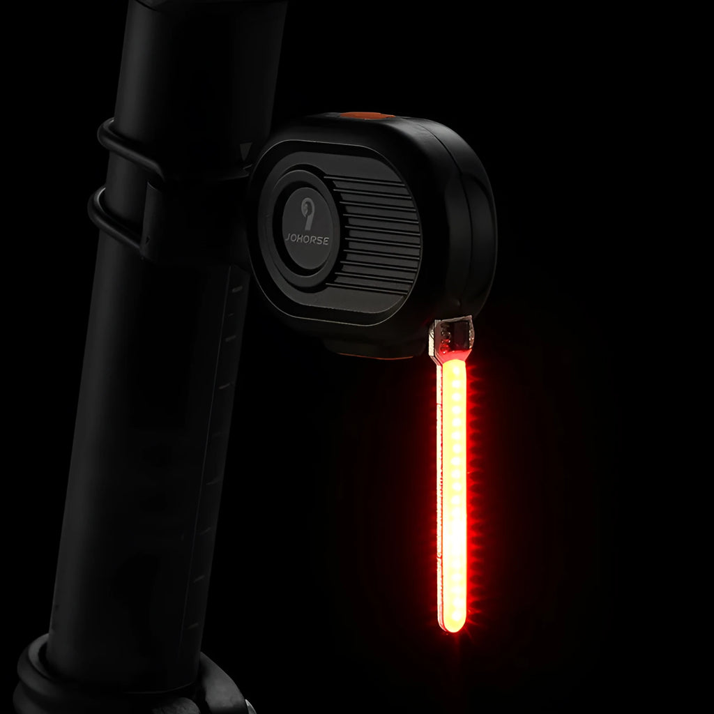 Bicycle rear safety light with colourful running water LED effect mounted on a seat post.