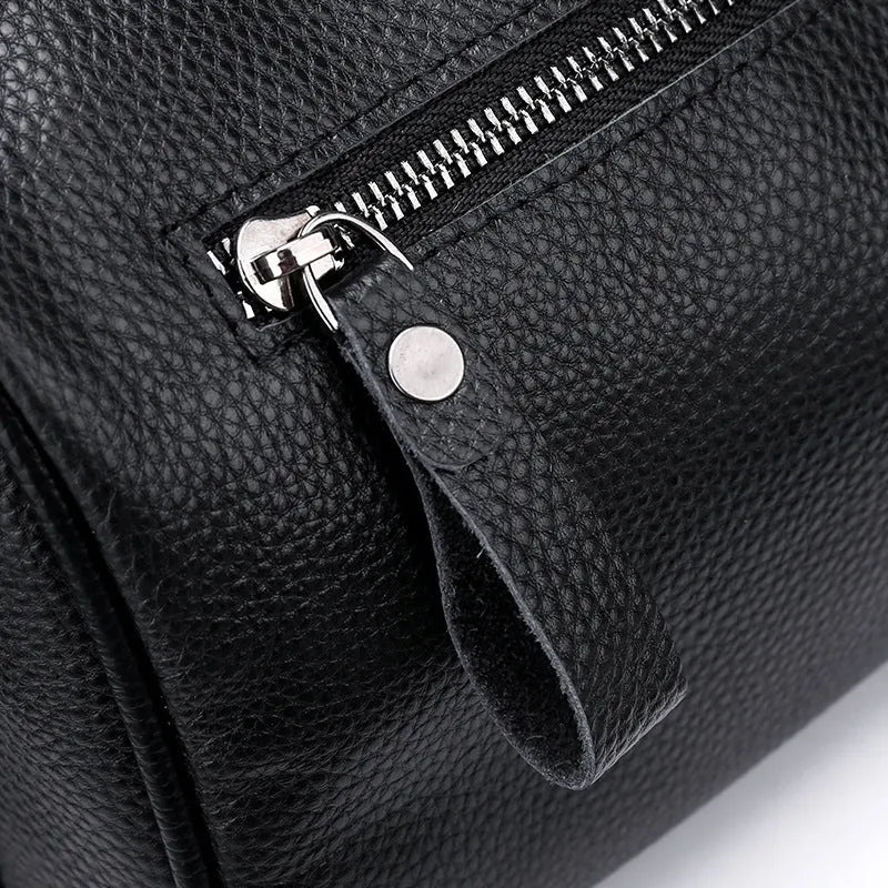Black genuine leather one-shoulder crossbody bag showing its large capacity and crossbody strap.
