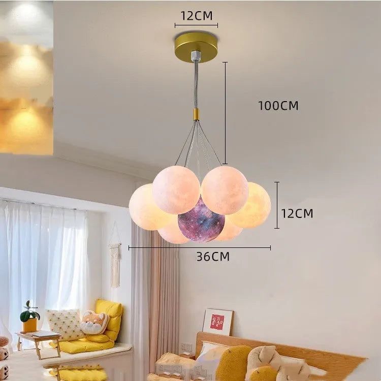 Nordic fish-shaped pendant chandelier with cluster of spherical moon bubble lights in gold or black finish.