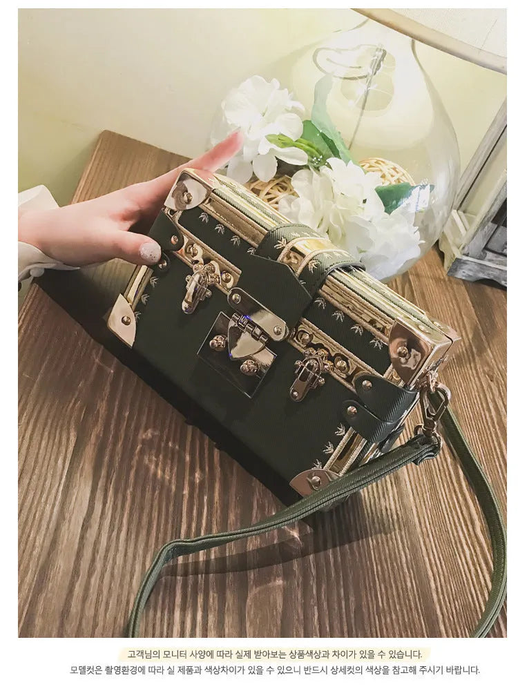 Women's structured shoulder bag with flap closure and adjustable crossbody strap in black or green
