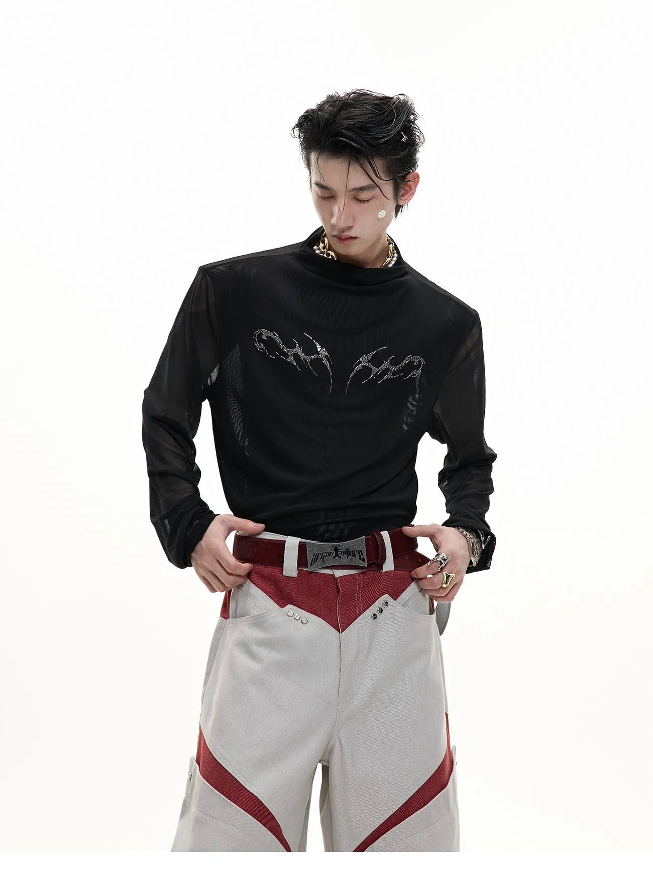 Man wearing a black slim fit long sleeve mesh base layer shirt.