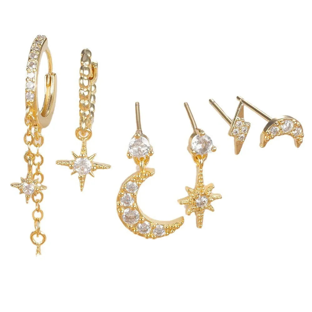 Six pairs of gold electroplated earrings with chain tassel and zircon stud designs representing different months
