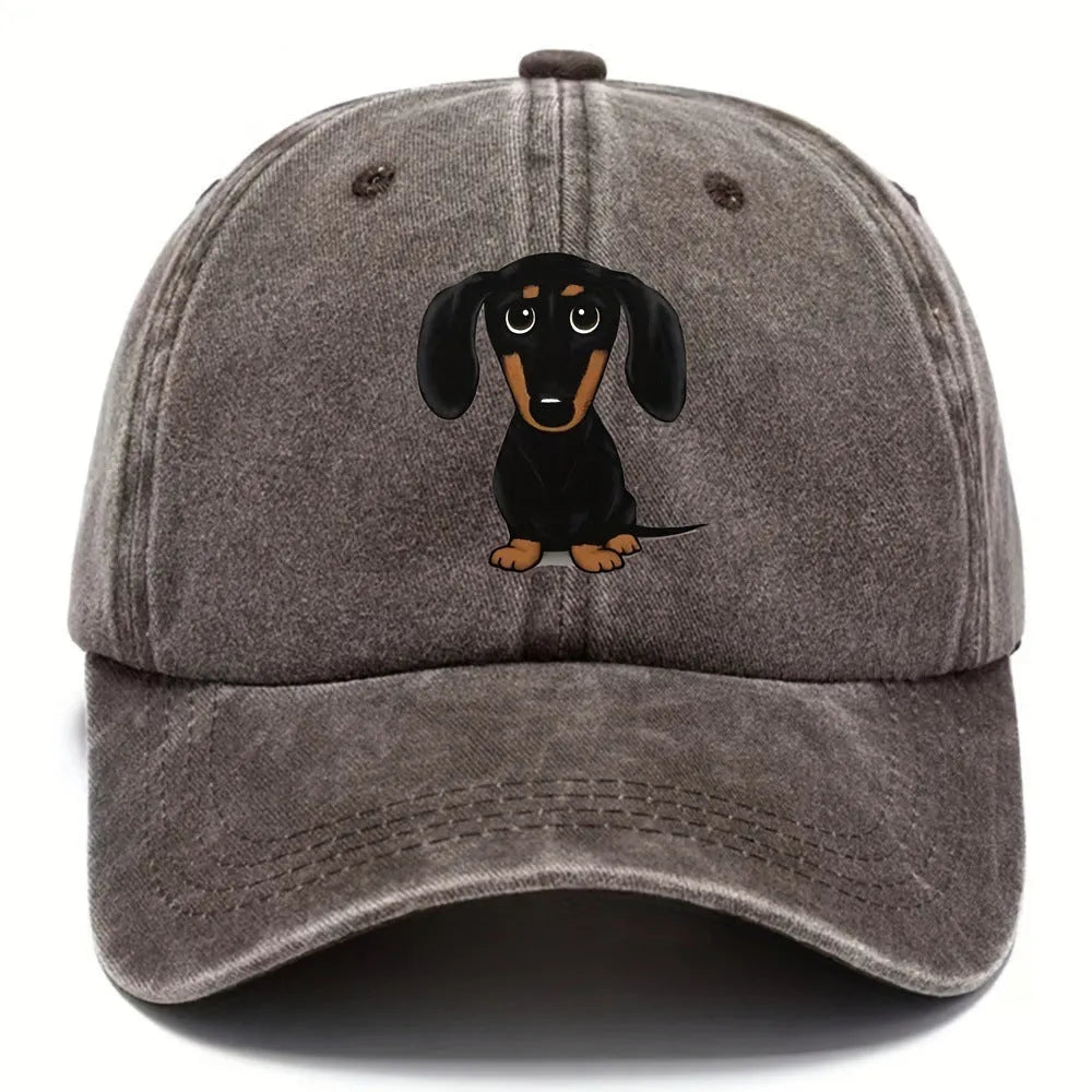 Retro washed blue cotton baseball cap with a printed dachshund design on the front and a peaked brim.