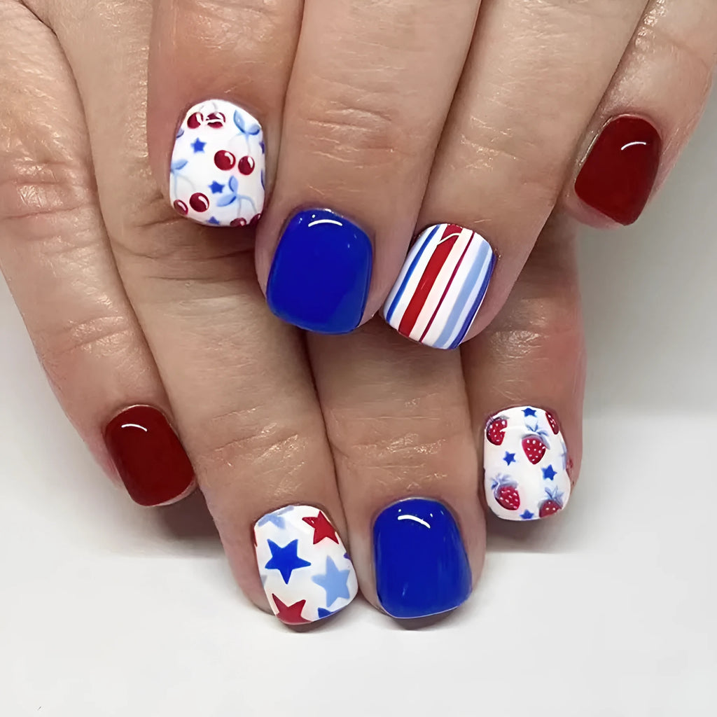 Short glossy false nails with red and blue strawberry and cherry Independence Day design