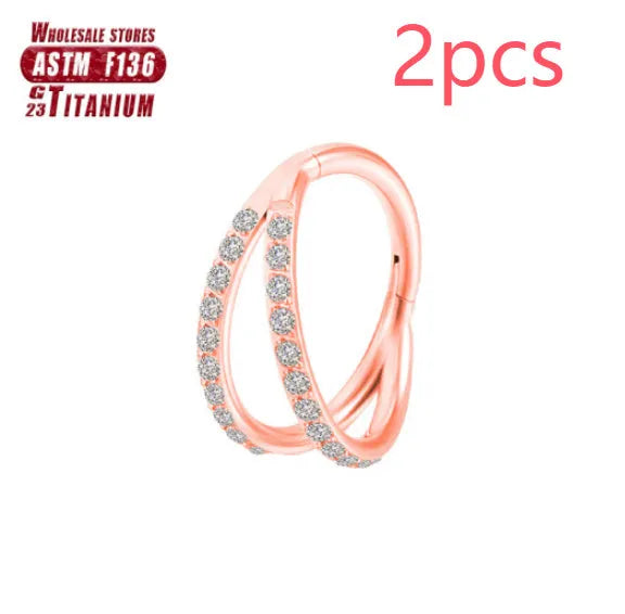 Titanium alloy nose ring on a plain background, shown in silver and gold finishes.