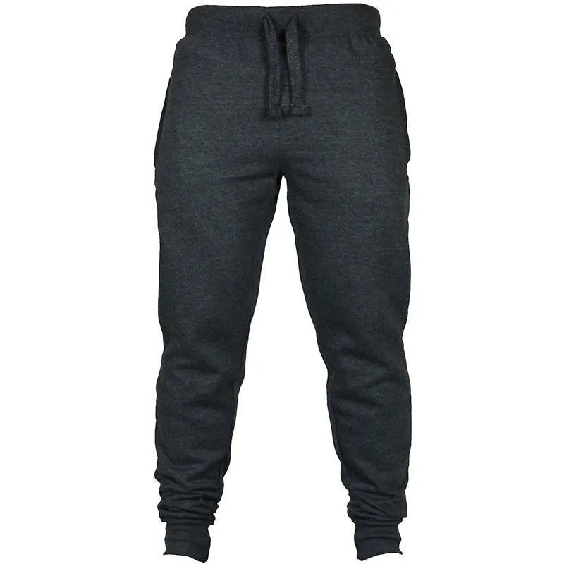 Man wearing solid black loose-fit cotton fleece pants with a drawstring waistband.