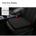 Black rectangular car seat cushion with 6cm thickness on a car seat.