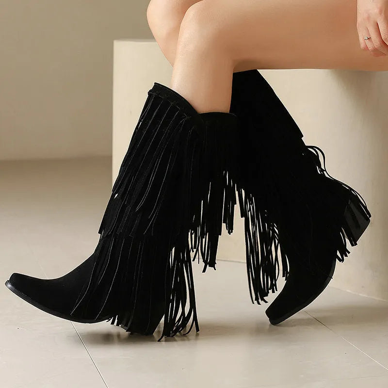 Women's beige suede mid-calf boots with a chunky heel and tassel detail on display.