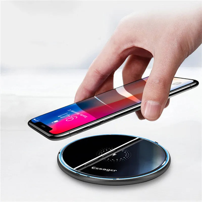 Black or white aluminium alloy 15W Qi wireless charging pad with LED light on a desk.