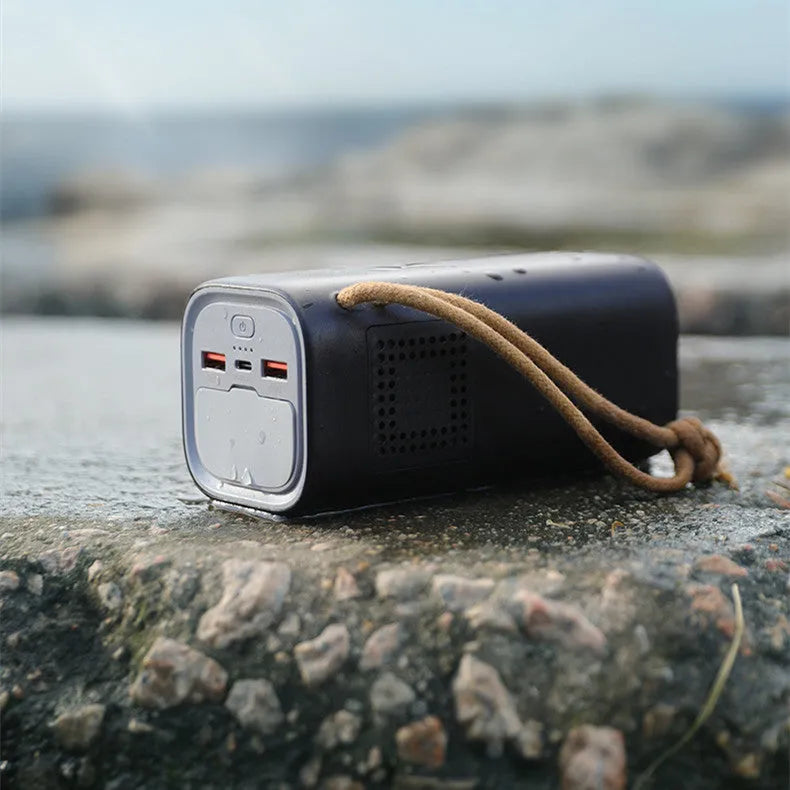 Black portable power bank with solar panel and multiple charging ports for outdoor emergency use