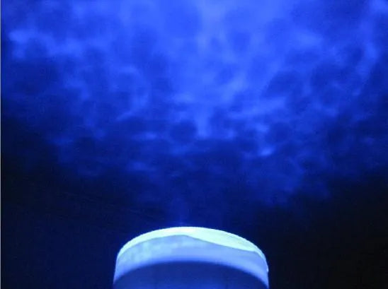 Blue ocean theme LED projection lamp mounted on a ceiling for children's room activities.