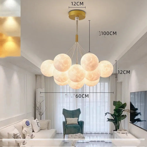 Nordic fish-shaped pendant chandelier with cluster of spherical moon bubble lights in gold or black finish.