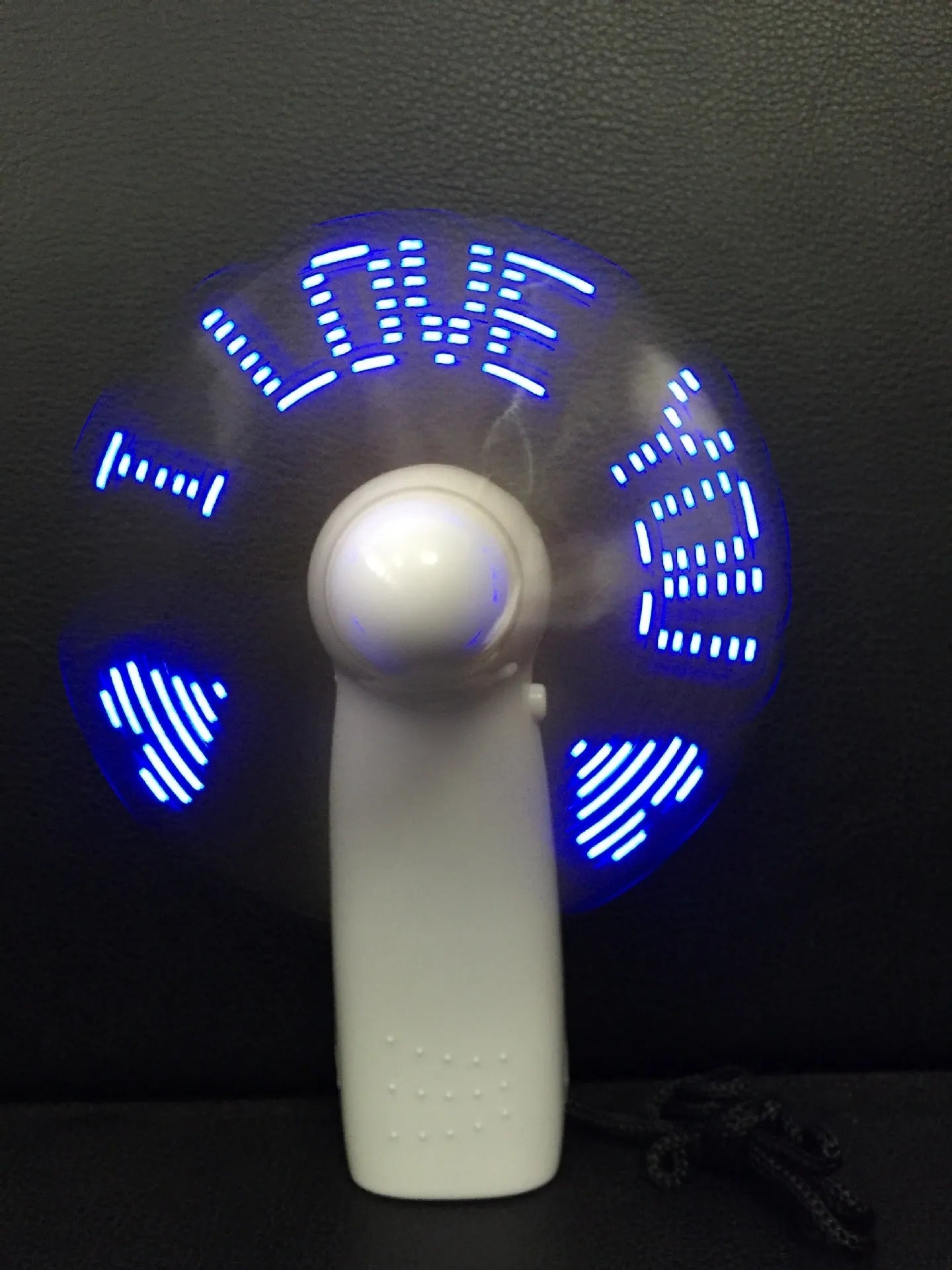 White handheld mini fan with flashing LED I Love You pattern in blue and red colours
