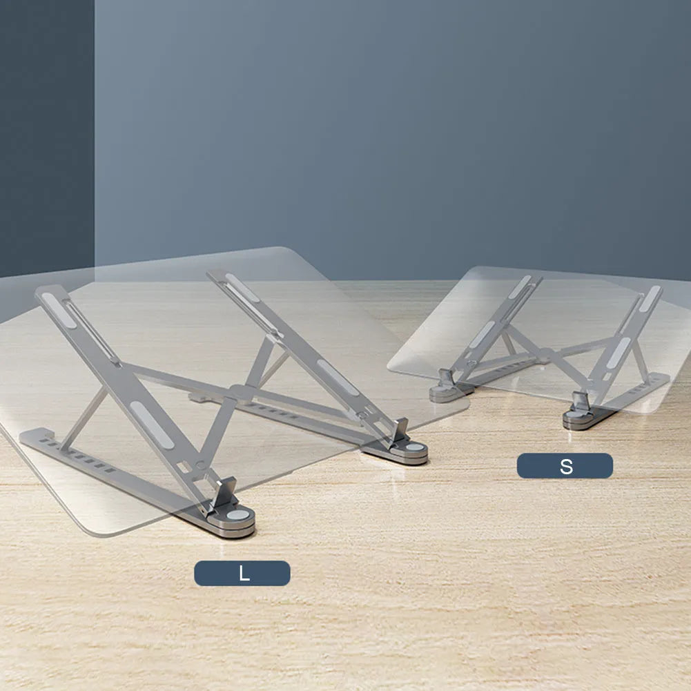 Deep grey portable aluminium laptop stand, folded flat next to an open laptop showing its adjustable height.