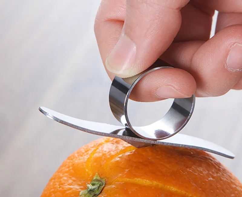Silver stainless steel ring orange peeler on white background showing 7.5cm tool with finger ring
