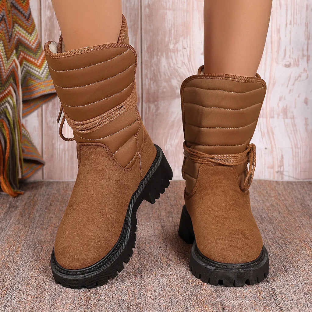 Women's black suede snow boots with chunky heel, lace-up design, and fleece lining