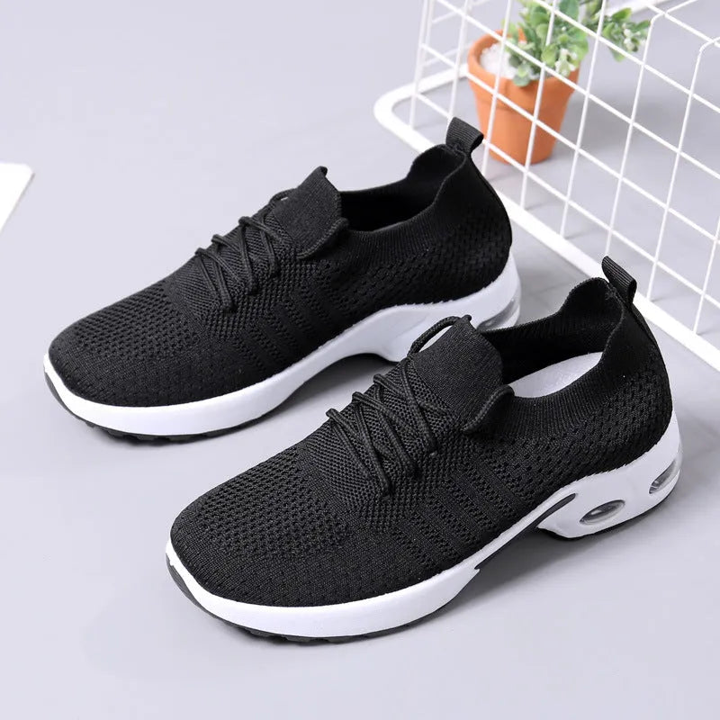 Women's black mesh casual sneakers with round toe, lace-up front, and a soft PVC sole.