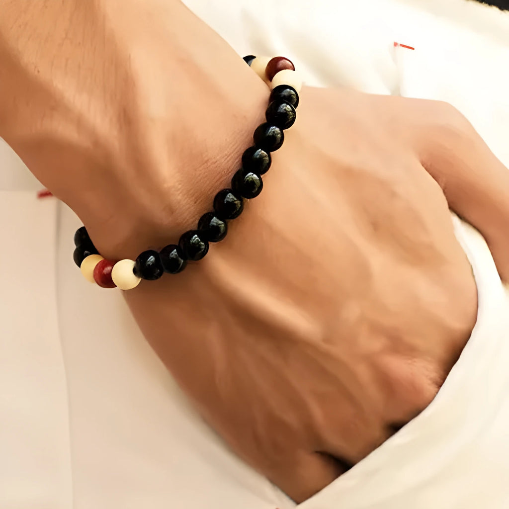 Unisex ethnic-style beaded bracelet made from natural lava stone on a wrist.