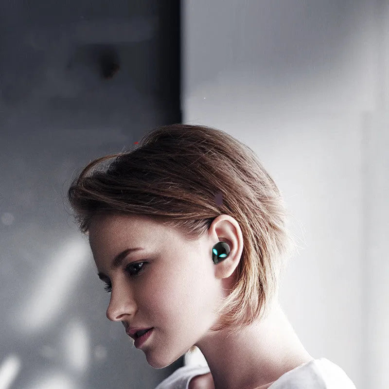 Creative Outer T8 Starman black and white alien design Bluetooth earbuds with coloured lights and wireless charging case.