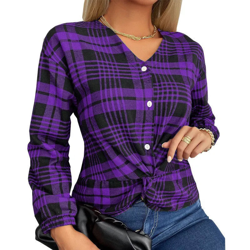 A woman wearing a loose-fitting purple plaid casual shirt with regular sleeves.