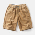 Men's khaki retro American-style cargo shorts with straight-leg cut on mannequin