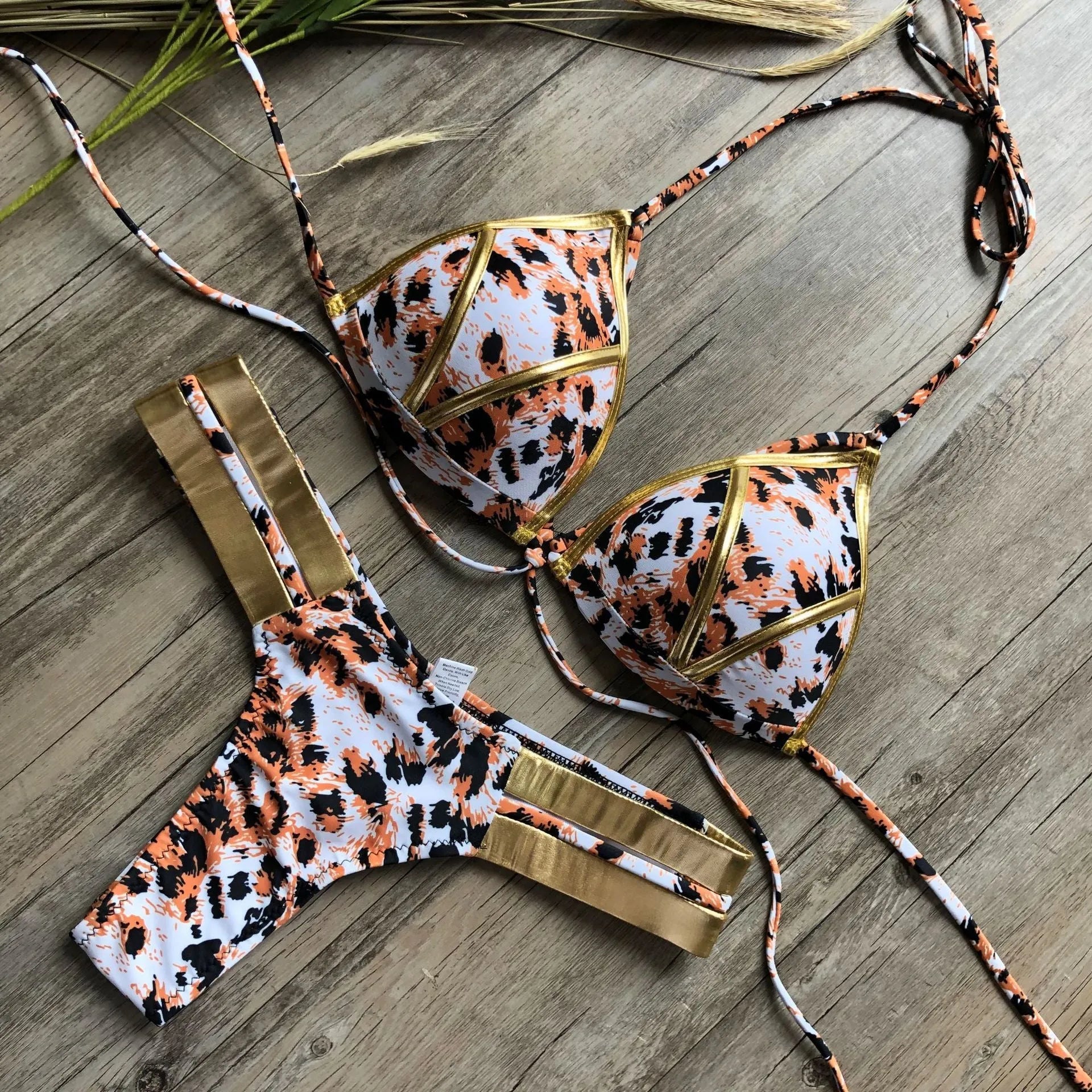 Women's bronzing bikini swimsuit with removable pads and cotton lined cups on a mannequin.