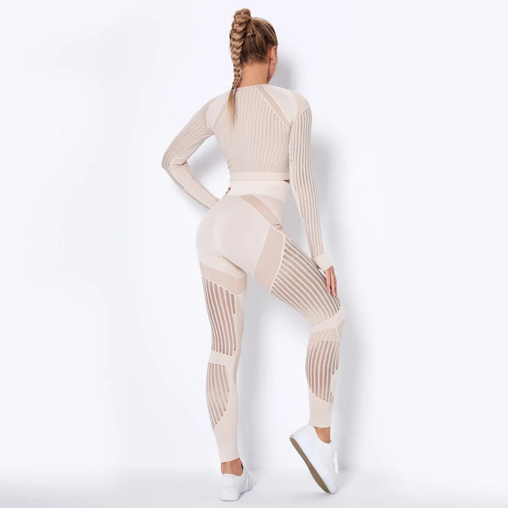 Women's black seamless knitted long-sleeved yoga wearsuit with stripe pattern, shown in a yoga pose.
