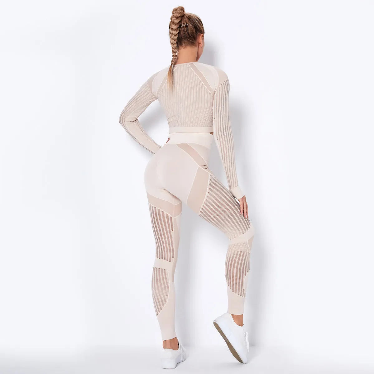 Women's black seamless knitted long-sleeved yoga wearsuit with stripe pattern, shown in a yoga pose.