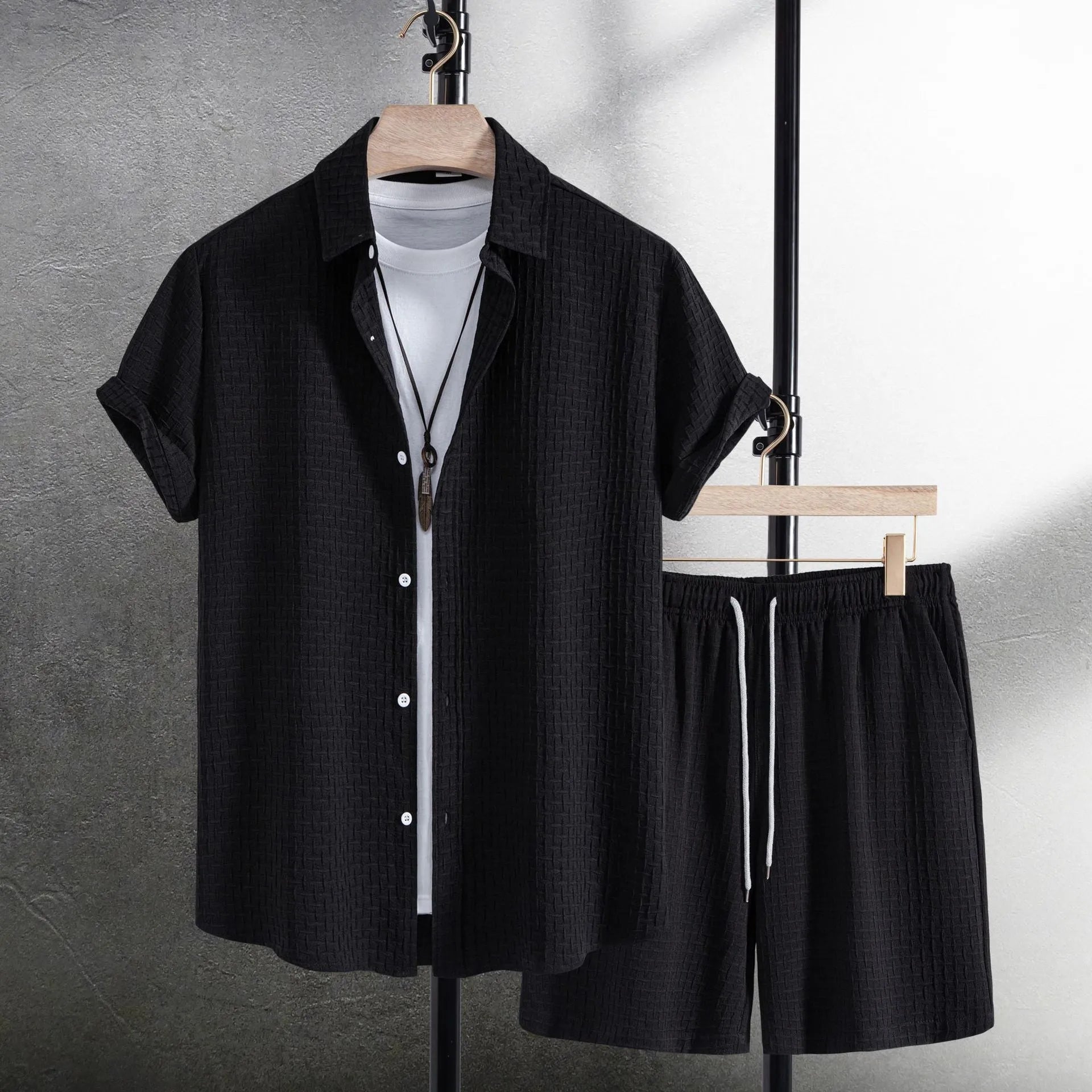 Men's black cotton blend short sleeve shirt and matching shorts set displayed together