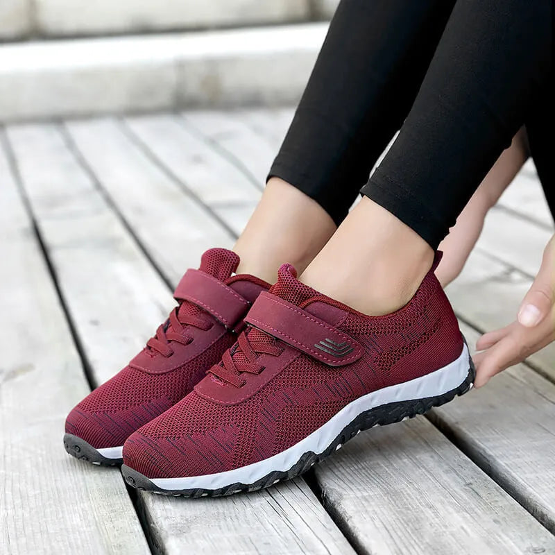 Women's low-top wedge heel shoes with mesh upper and Velcro strap in a solid colour.