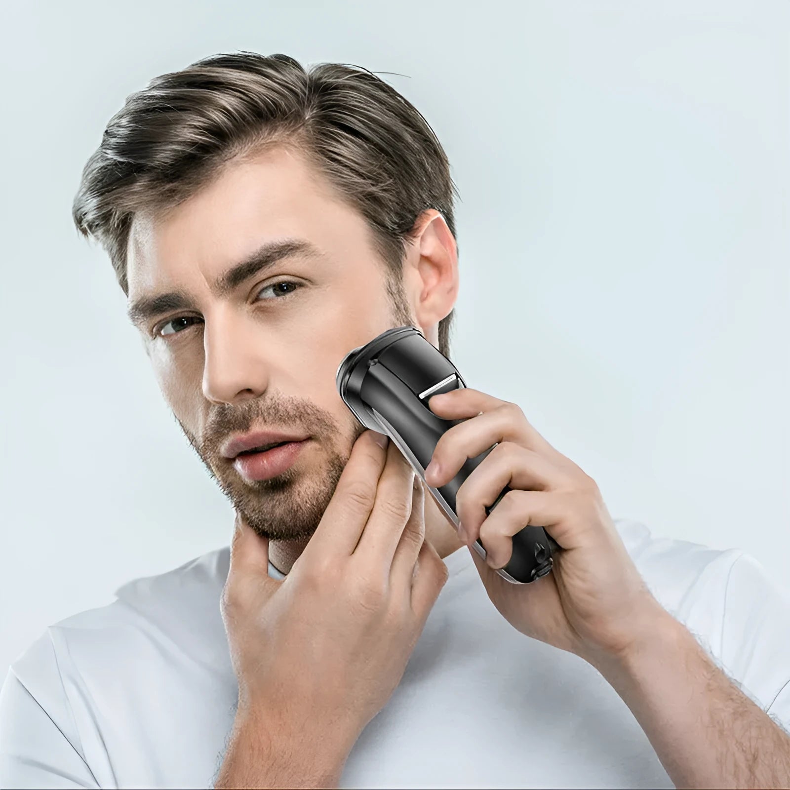 Men's electric shaver grooming kit with three rotating heads and a pop-up sideburn trimmer on a USB charging cable