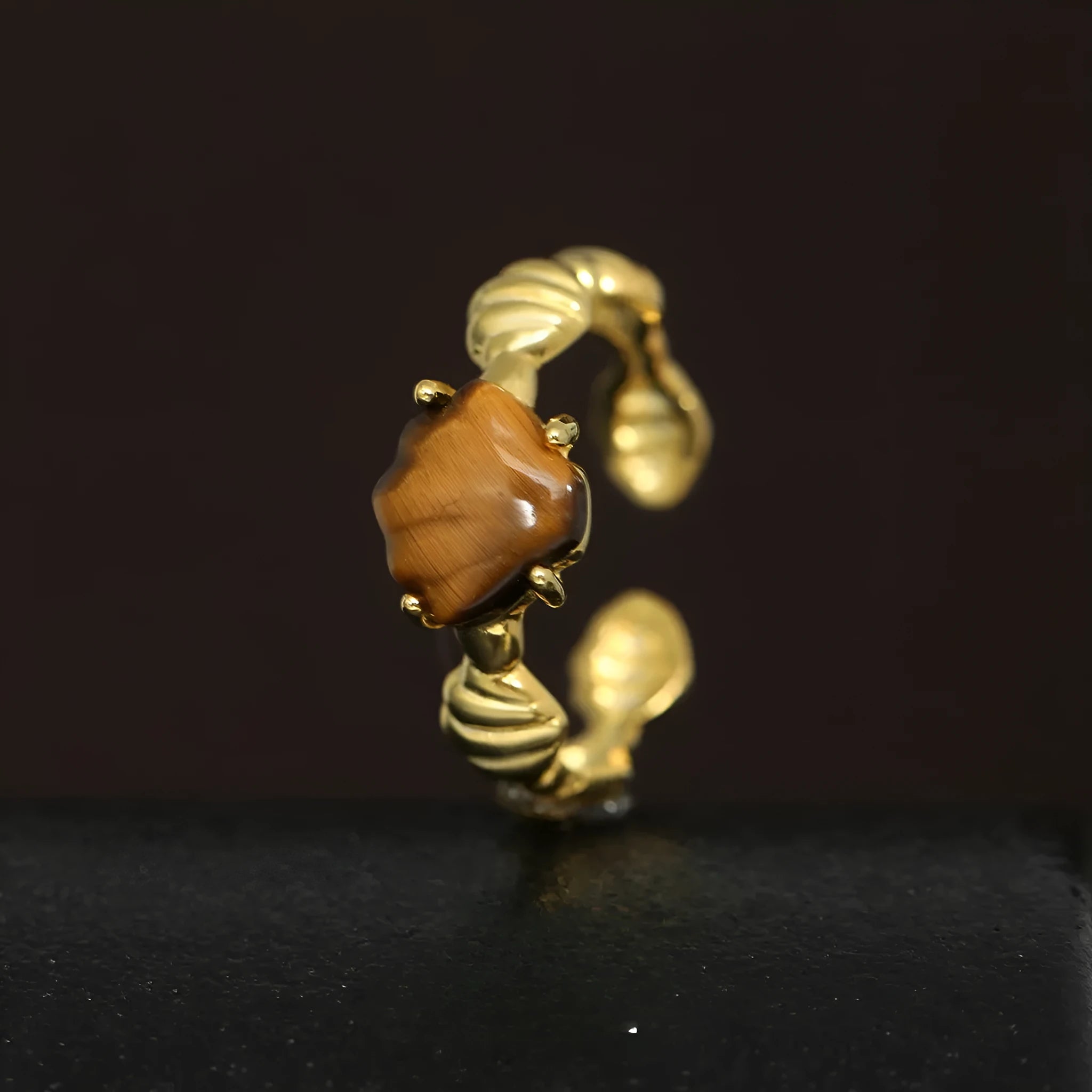 Women's adjustable silver ring with sculpted shell design and tiger eye stone in gold finishes